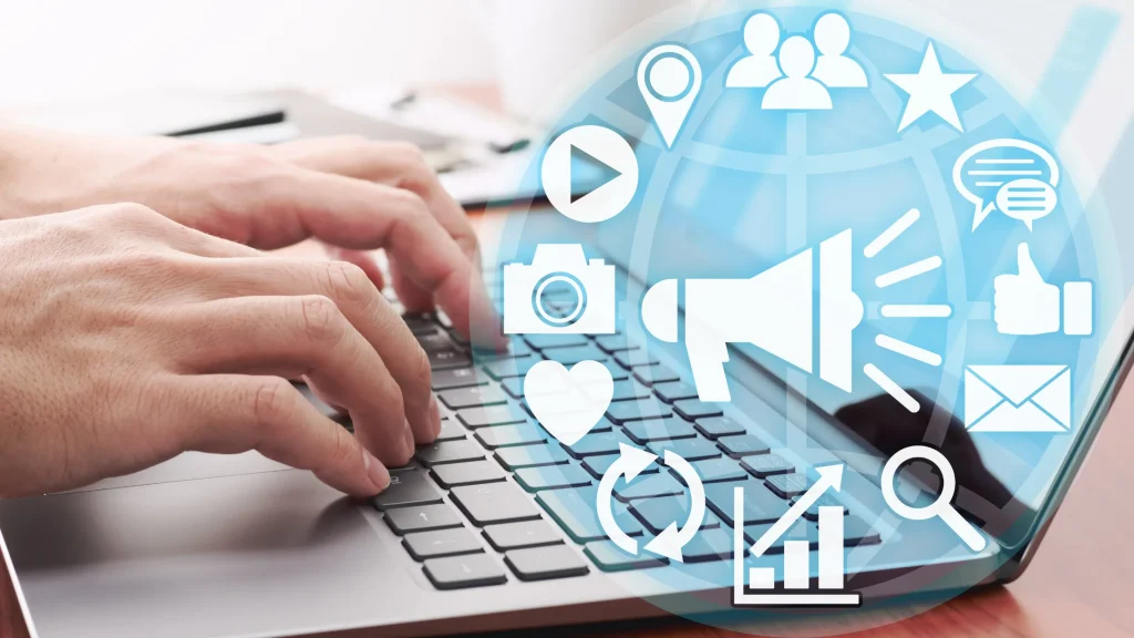 Hands typing on a laptop with digital marketing icons, a visual representation of digital marketing mentorship.