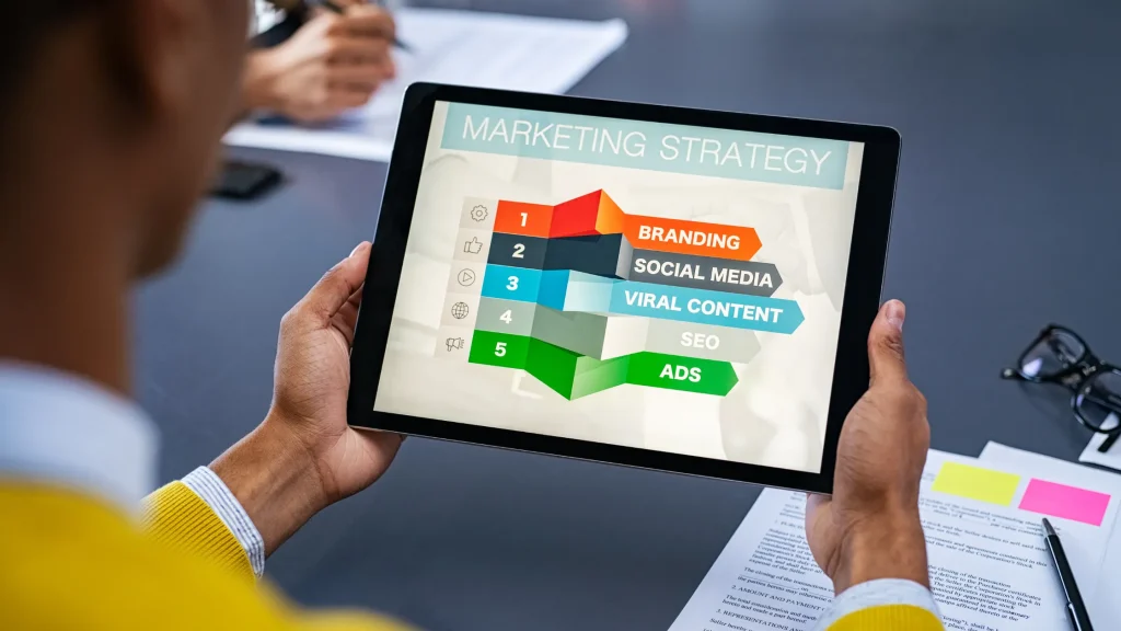 Person holding a tablet displaying a marketing strategy, ideal for digital marketing mentorship.
