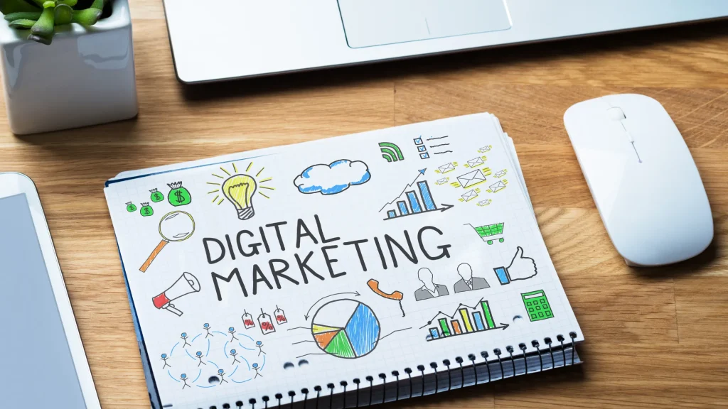Hand-drawn digital marketing elements on a notebook, representing faceless Digital Marketing Strategy concepts.