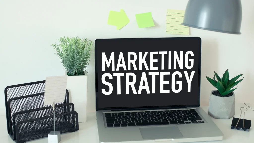 Laptop displaying the words 'MARKETING STRATEGY' representing Montana Digital Marketing Strategy in a modern workspace.